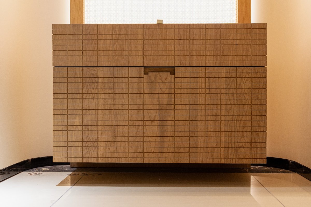 Reeded oak dresser with a fine grid front and recessed pull, in a warm minimalist interior