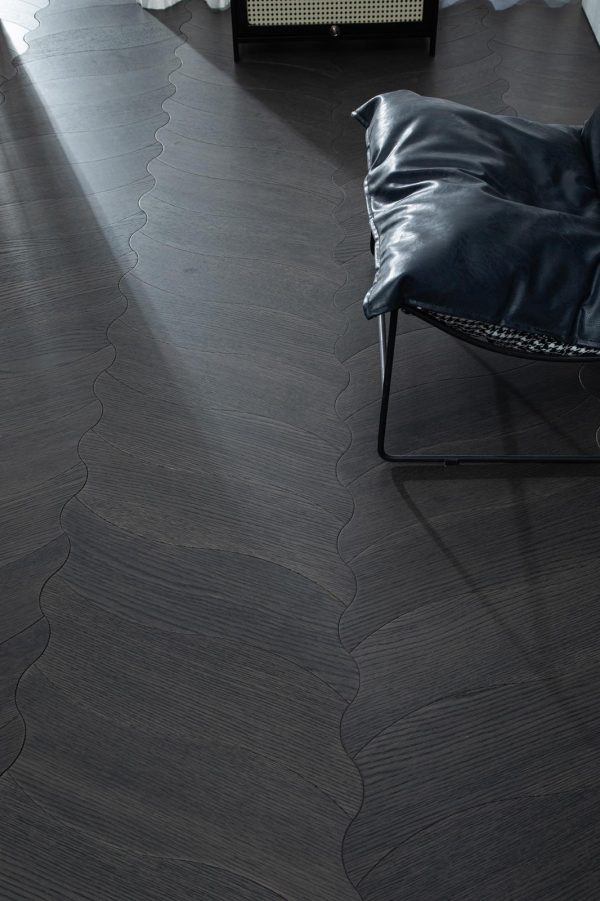 Close-up view of the Obsidian Flow Herringbone floorboard with detailed craftsmanship in dark-stained oak