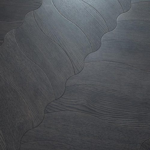 Close-up of Obsidian Flow Herringbone floorboard pattern in dark-stained oak with flowing curves