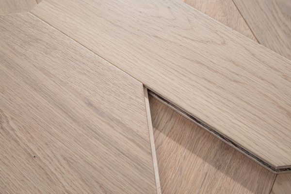 Close-up of White Oak Luxe floorboard edges fitting together.