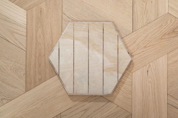 Honey Comb Luxe hexagonal oak floorboard with detailed wood grain and hexagon shape.