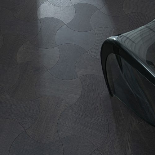 Obsidian Oak Dogbone Collection floorboard close-up, featuring dark-stained oak in a unique dogbone pattern.