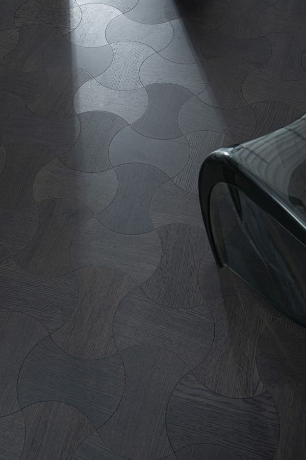 Obsidian Oak Dogbone Collection floorboard close-up, featuring dark-stained oak in a unique dogbone pattern.