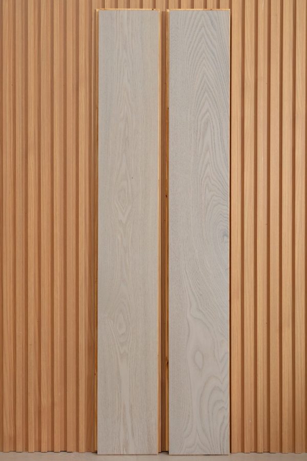 Close-up of White Oak Floorboard planks against a wooden backdrop, showcasing texture and grain.