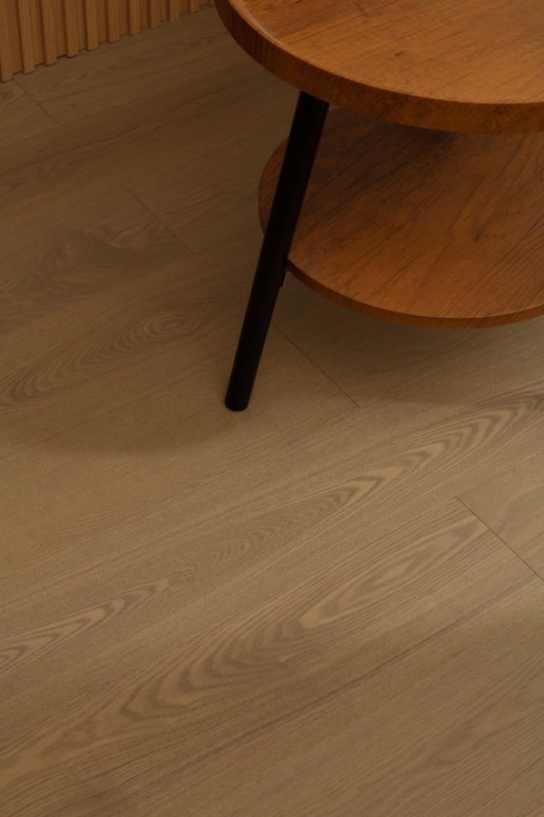 Close-up of oak floorboards displaying a warm caramel tone and natural wood grain.