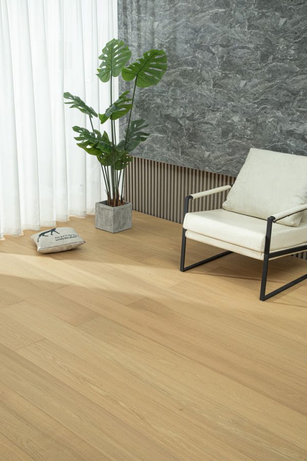 European Honey Oak floorboards with a modern armchair and green plant in the background.