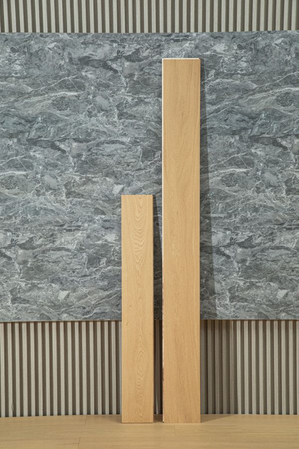 Two sizes of European Honey Oak floorboards shown against a textured gray wall.