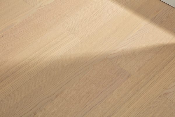 Large natural oak classic floorboard close-up, showing the light wood grain texture and smooth finish.