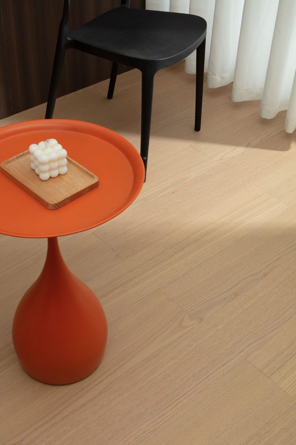 Bright and modern floorboard setup with minimalist furniture highlighting the natural oak grain and warm tone.