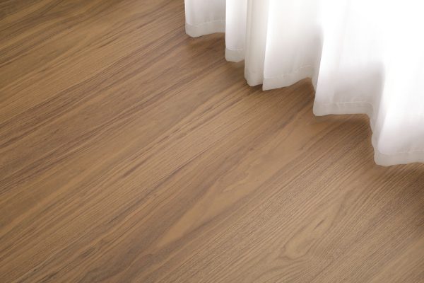 Walnut wood floorboards with a warm, natural finish.