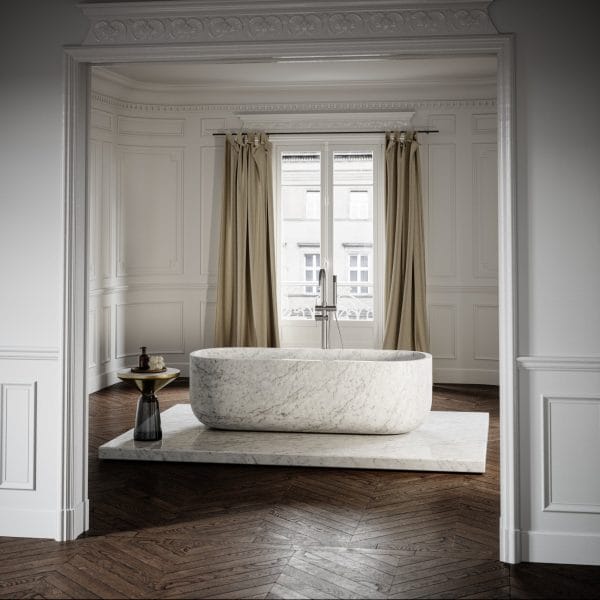 Daen Bend Carrara Marble Freestanding Bath 1780mm in a luxurious, classic bathroom with herringbone wood flooring and elegant wainscoting.