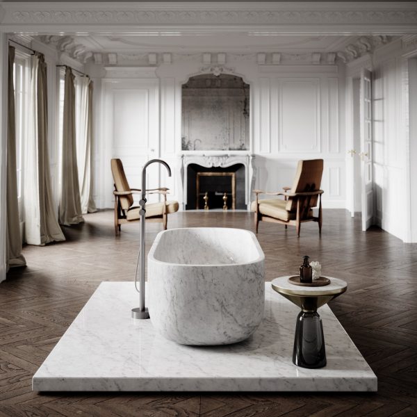 Daen Bend Carrara Marble Freestanding Bath 1780mm placed in a spacious, classic living space with a fireplace and vintage furniture.