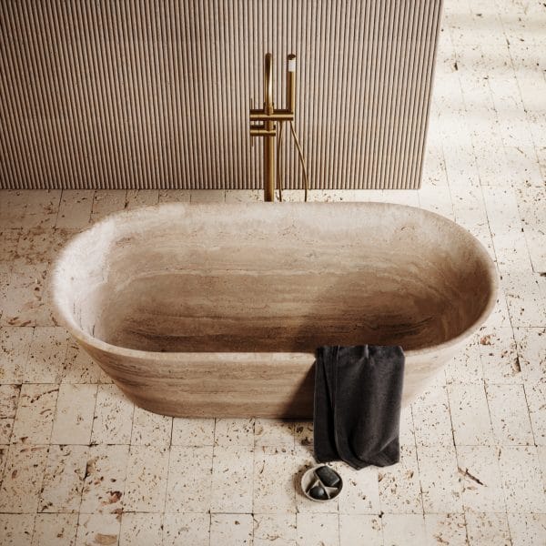 Daen Linear Classic Travertine Freestanding Bath 1700mm placed in a modern bathroom with textured wall paneling and natural stone flooring.