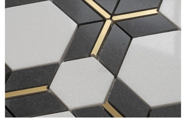 Close-up of Noir Opulence Hexagon Marble Mosaic Tile, featuring white and black marble with gold stainless steel inlays.